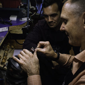 Master jeweller instructing apprentice jeweller in jewelry making.