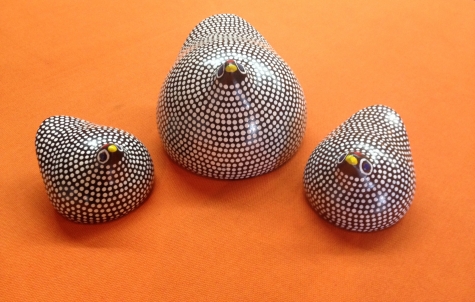 set of pottery stylised guinea fowl, a hen and two chick, black with white spots