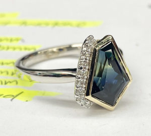 asymmetrical cut, Australian-sapphire ring with diamonds down one side, two-third view